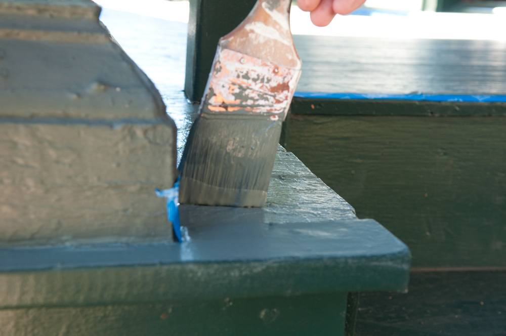 Painting stairs with blue color paint brush