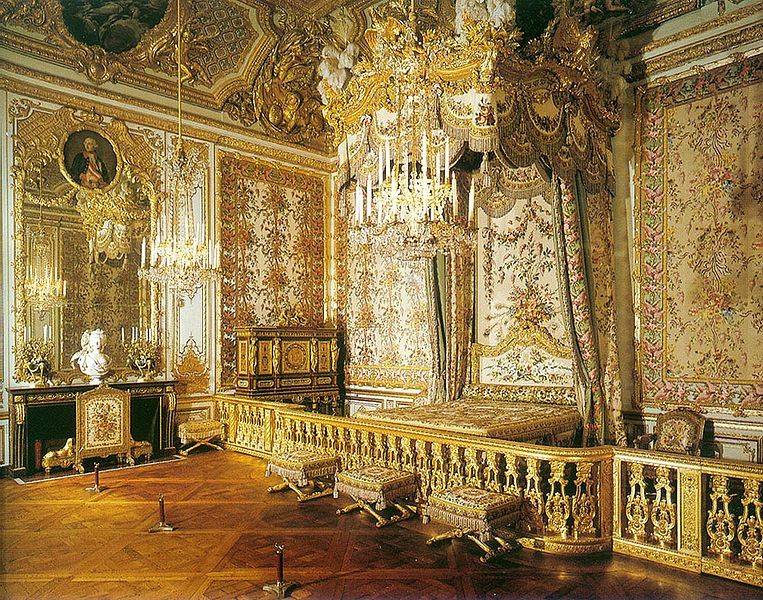 An intricately designed gold and white room.