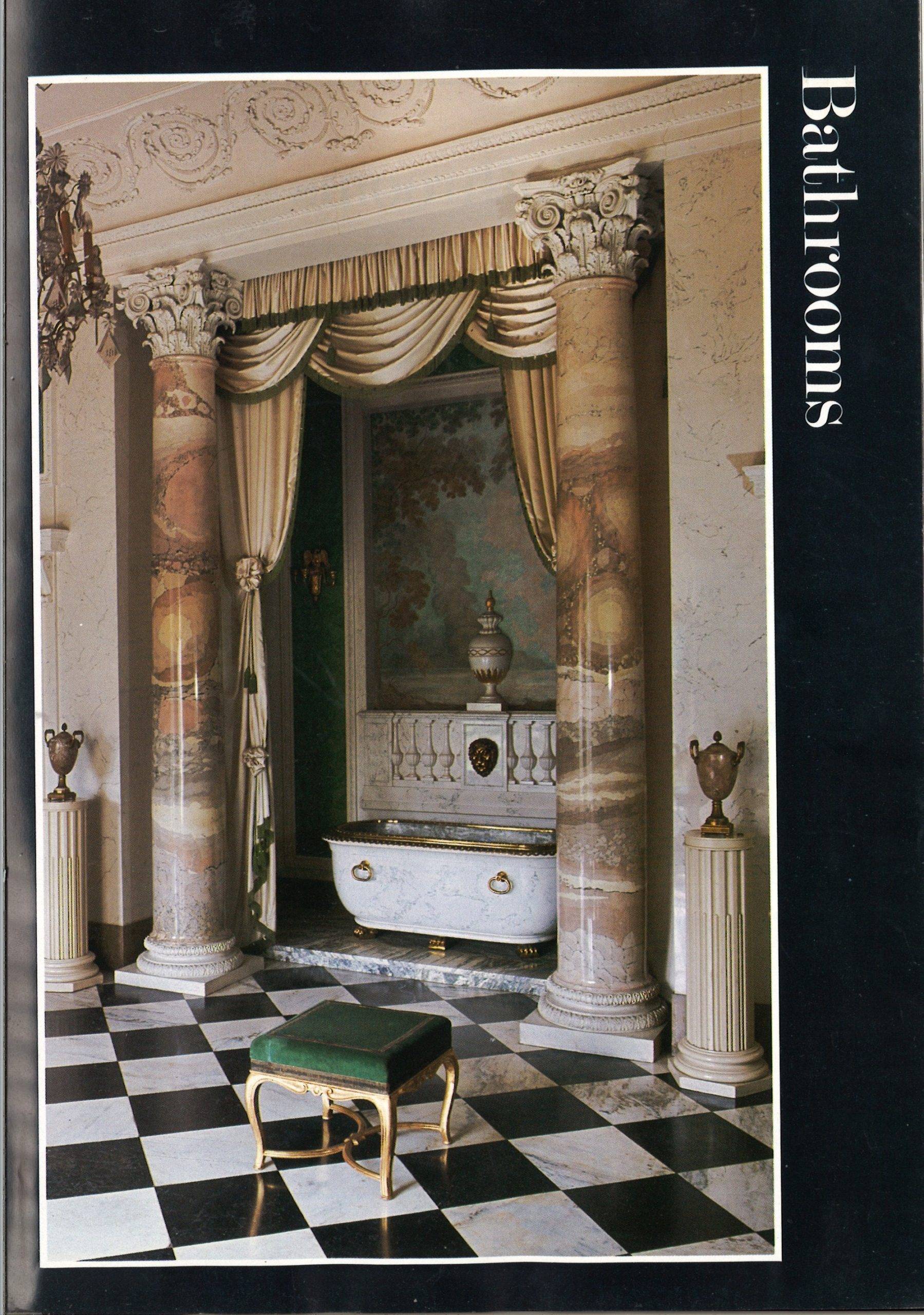 A checkered floor, a set back bath between two marble collumns.