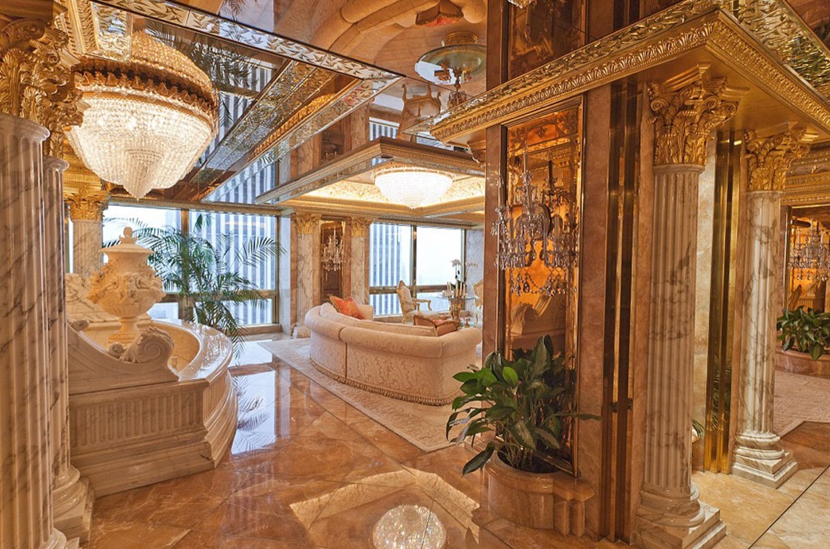 Ornate gold and white living room decor with marbled floor.