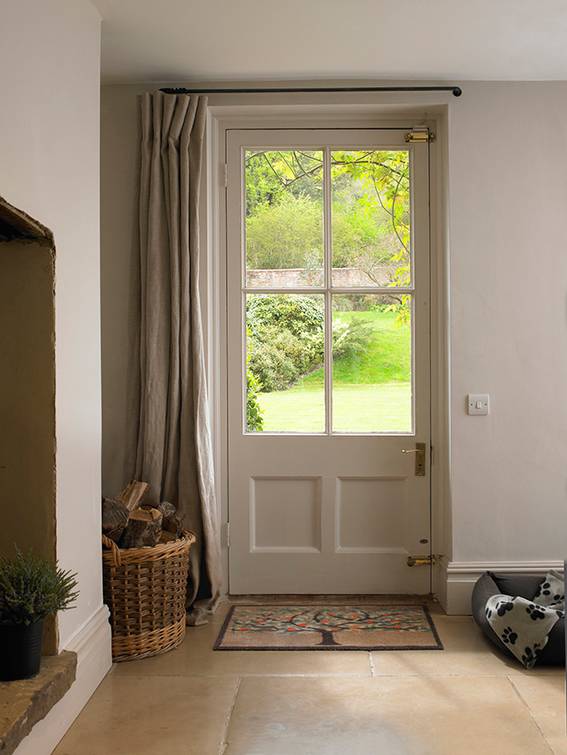 Hanging curtains over your front door is an easy way to keep your space warm.
