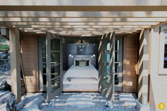 a basement bedroom with a walkout view of the Puget Sound.