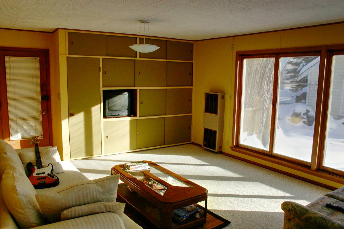 Furniture in a yellow painted living room.