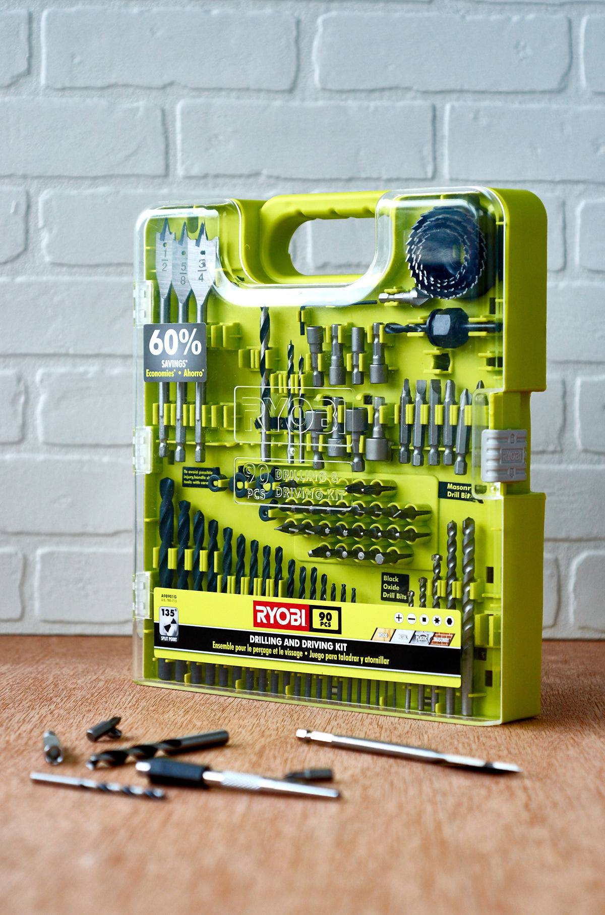 A drillbit set with some of the drill bits laying out of package in front of it.