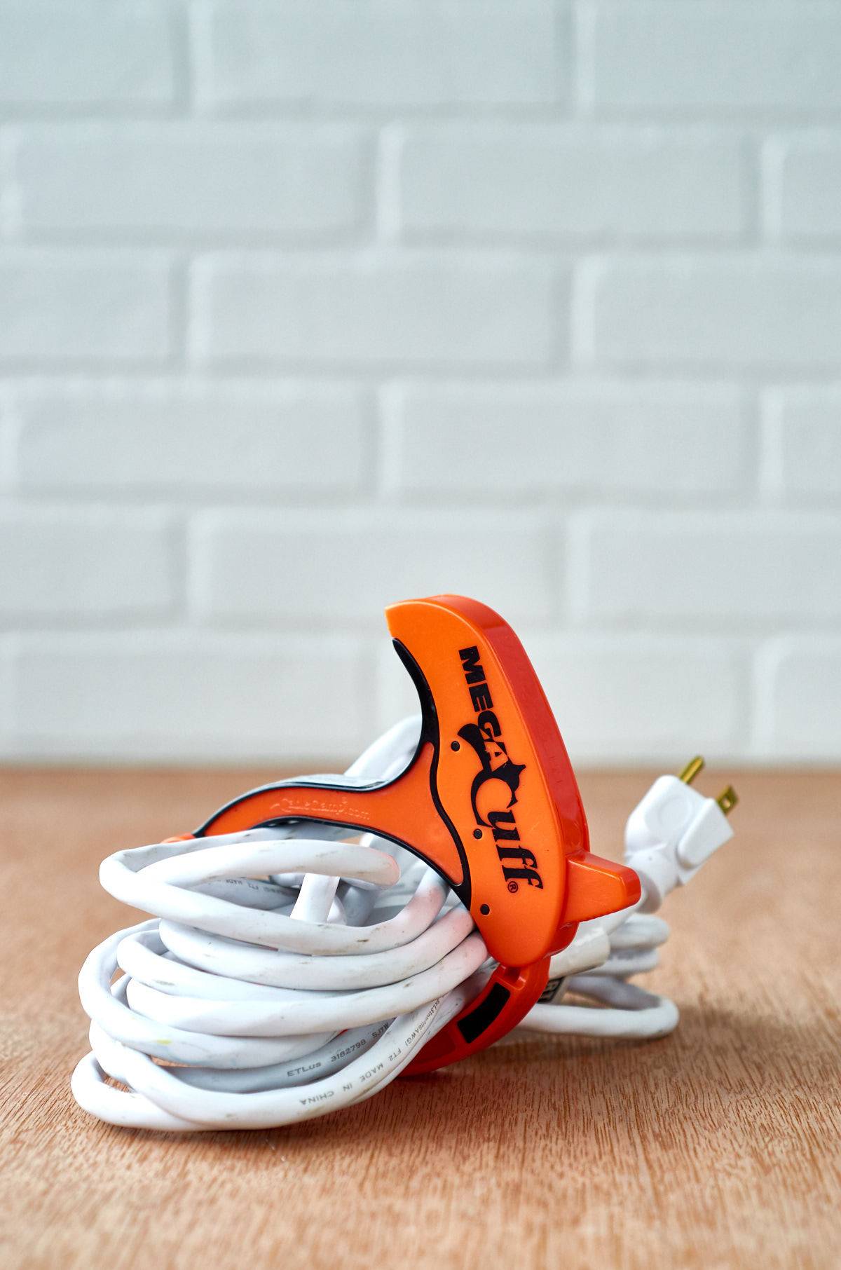 white electrical cord wrapped up on the floor