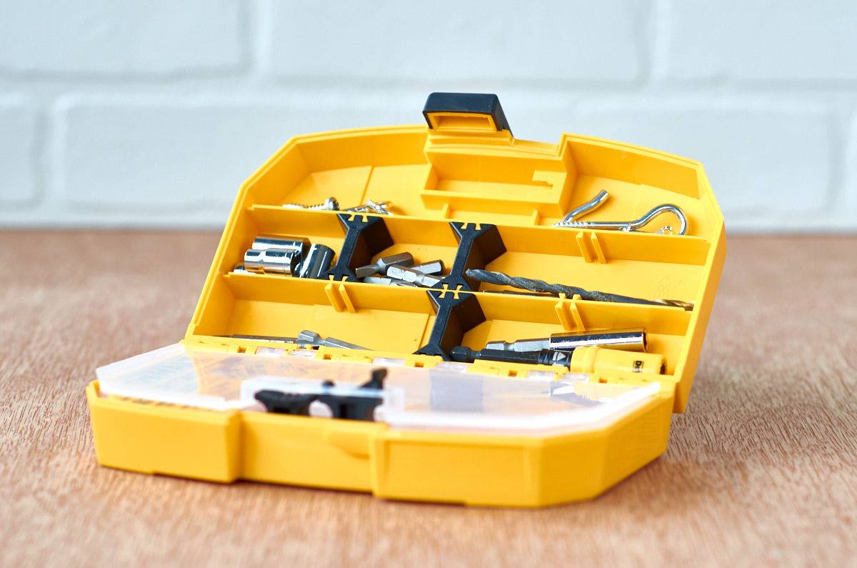 Yellow tool organizer sitting on a wood surface.