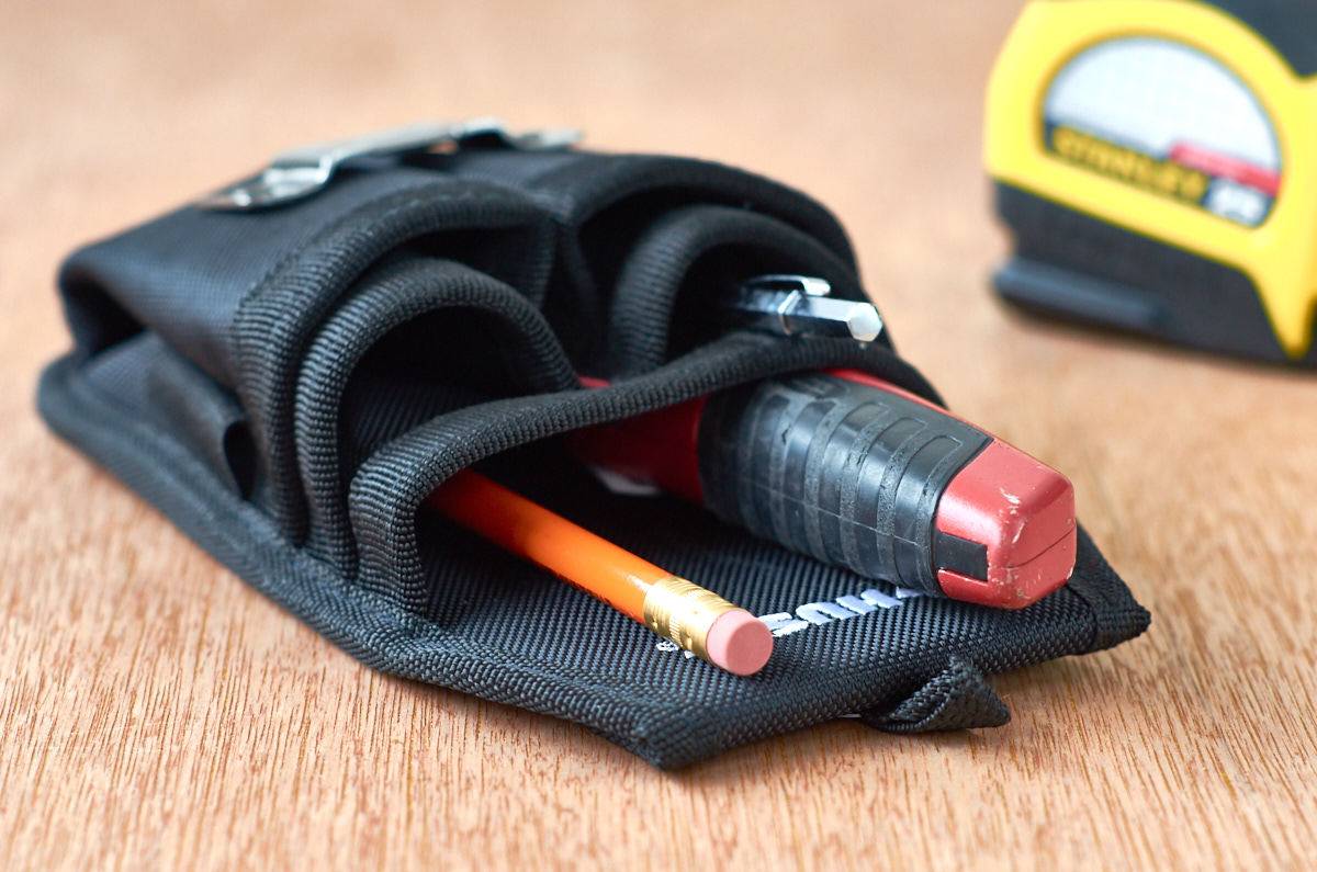 A black holster holding a tool and a pencil.