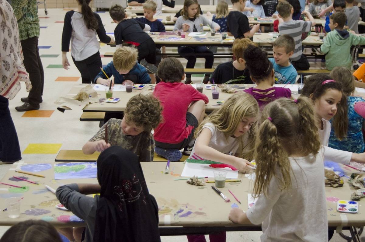 Children are painting in an art competition.