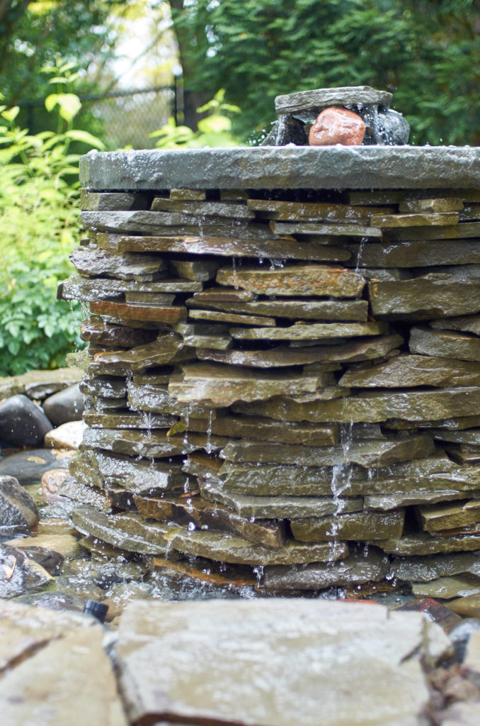 Adding Charm and Relaxation to a Backyard with a DIY Pond and Fountain