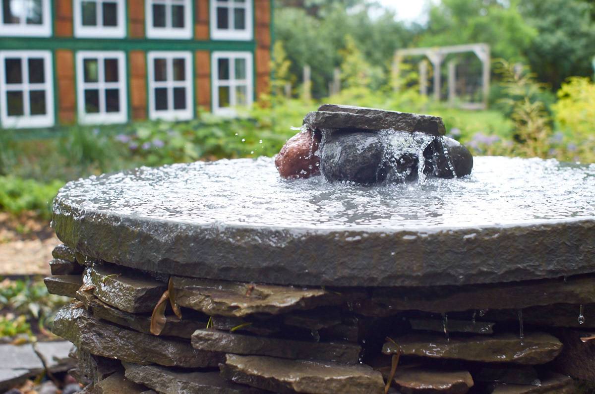 Small round shaped water fountain prepared with rocks.