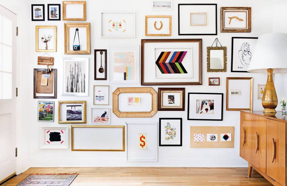 Different types of designer wall frames on a white wall.