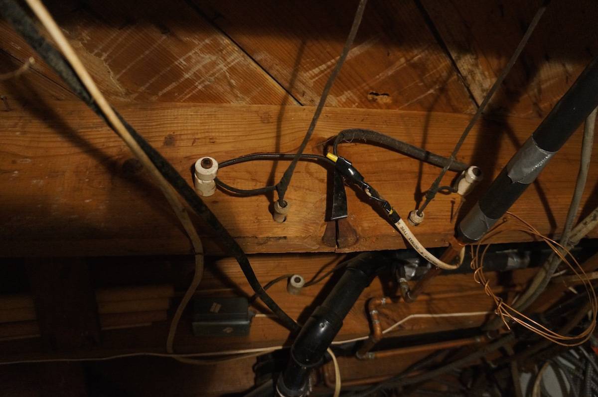 Wires and tools set up on shelves in a dark area.