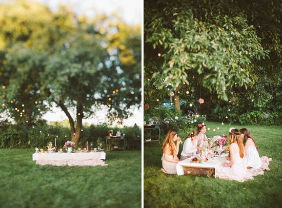 A family dressed in white picnicking under a tree.
