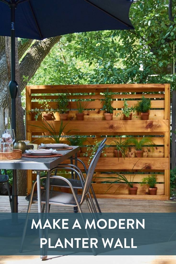 DIY Modern Planter Wall made from cedar fence pickets, with clear acrylic shelves