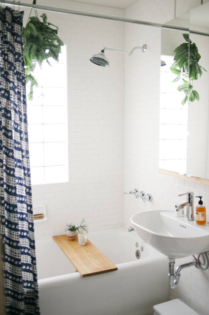 A tub with a board over it with a window that has the sun shining