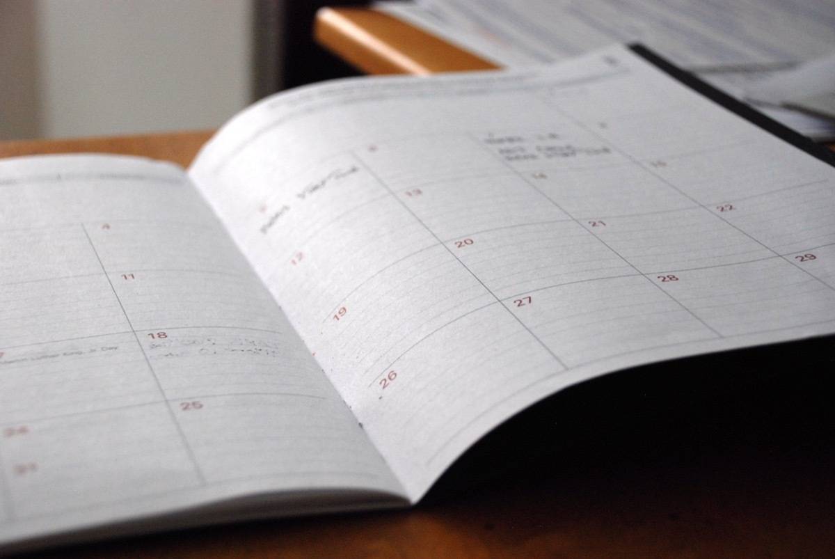 A book with a calendar is open on a desk.