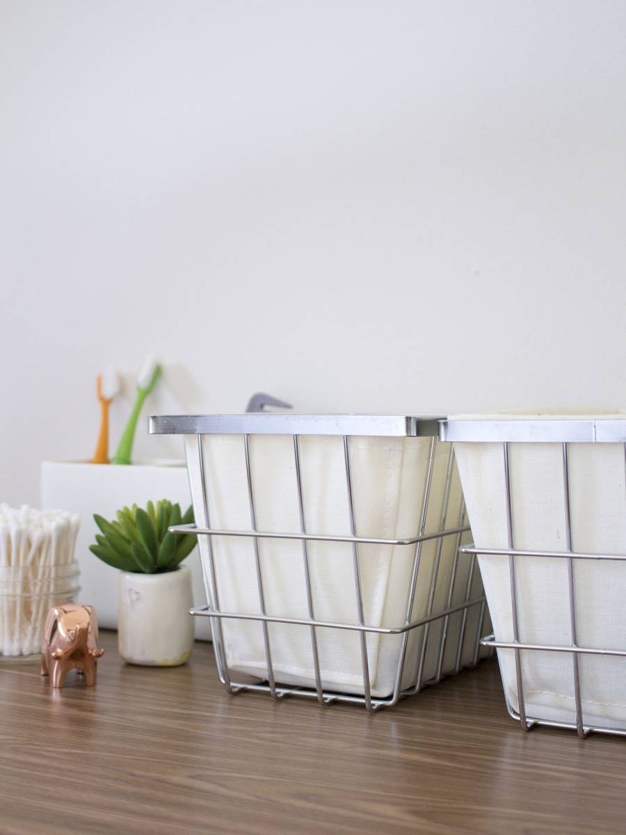 Ugly apartment bathroom decor: Use matching storage to hide all your toiletries