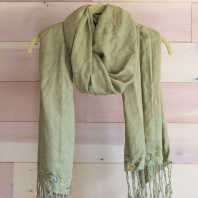 A green scarf on a hanger