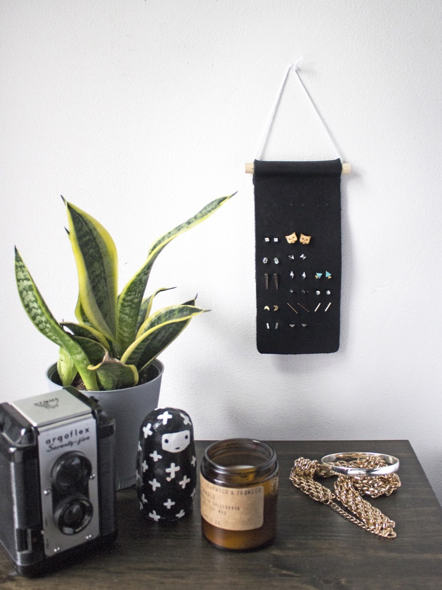 Minimal stud earring organizer you can make from a strip of leather