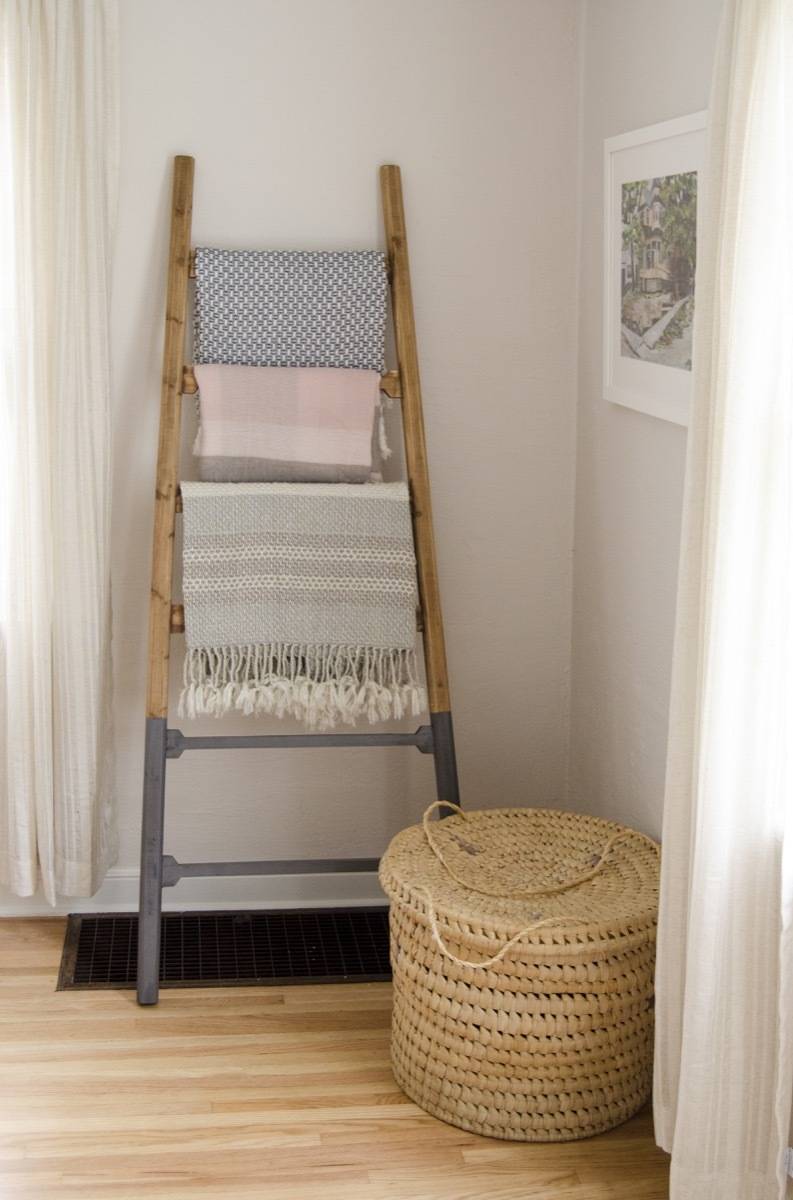 Blanket ladder with mid century modern chair and basket