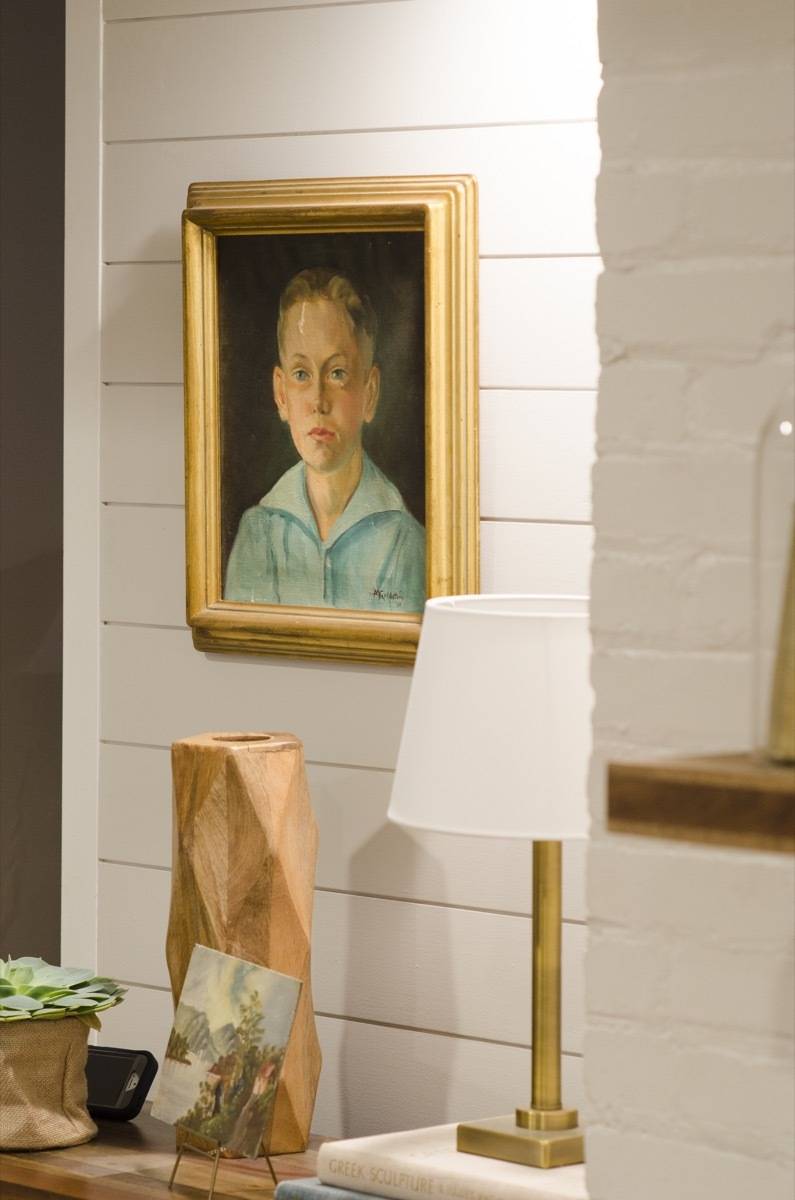 A picture of a boy hanging on a wall.