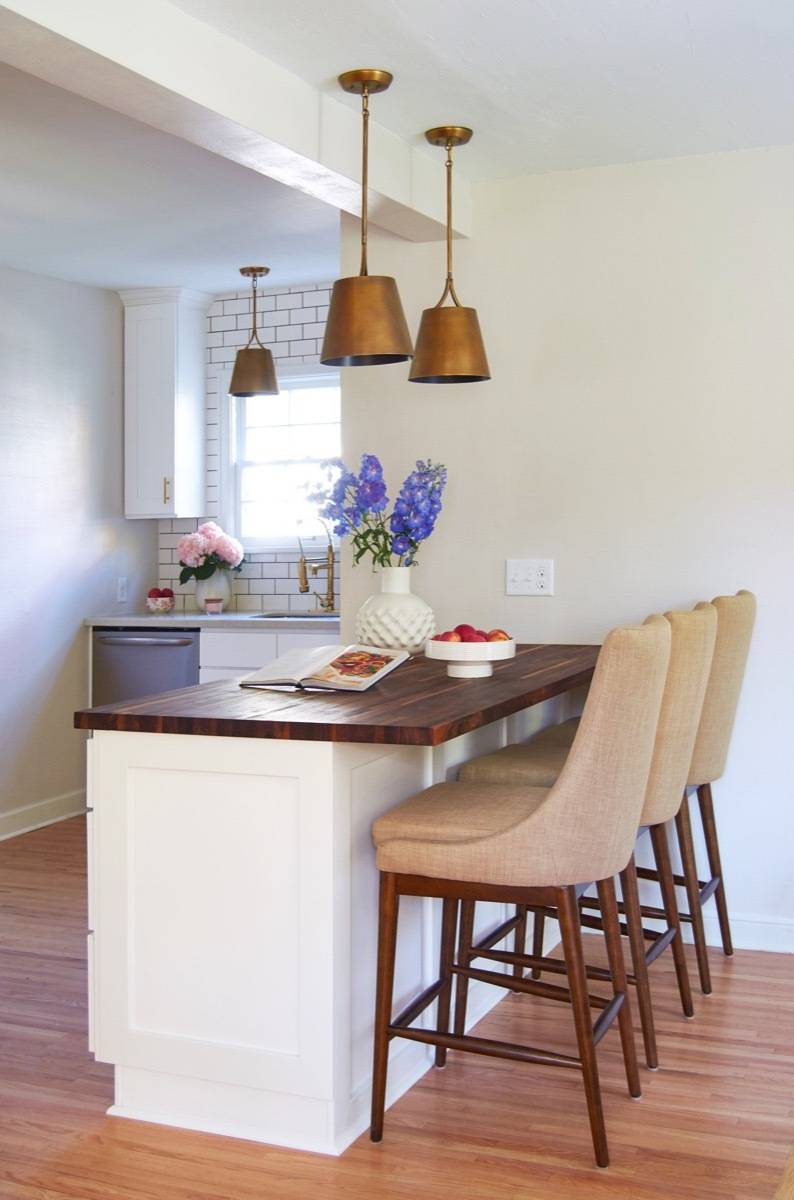 Butcher block countertop on island with white cabinets