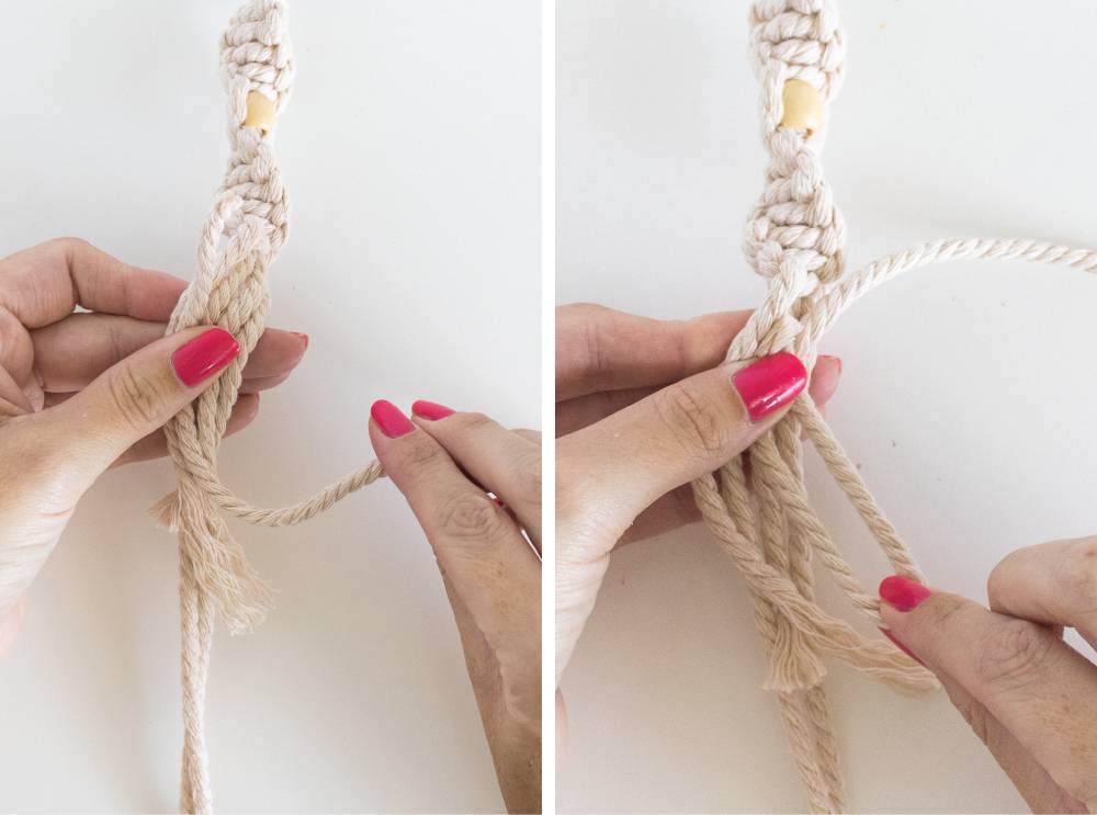 A person with pink fingernails is braiding a rope.