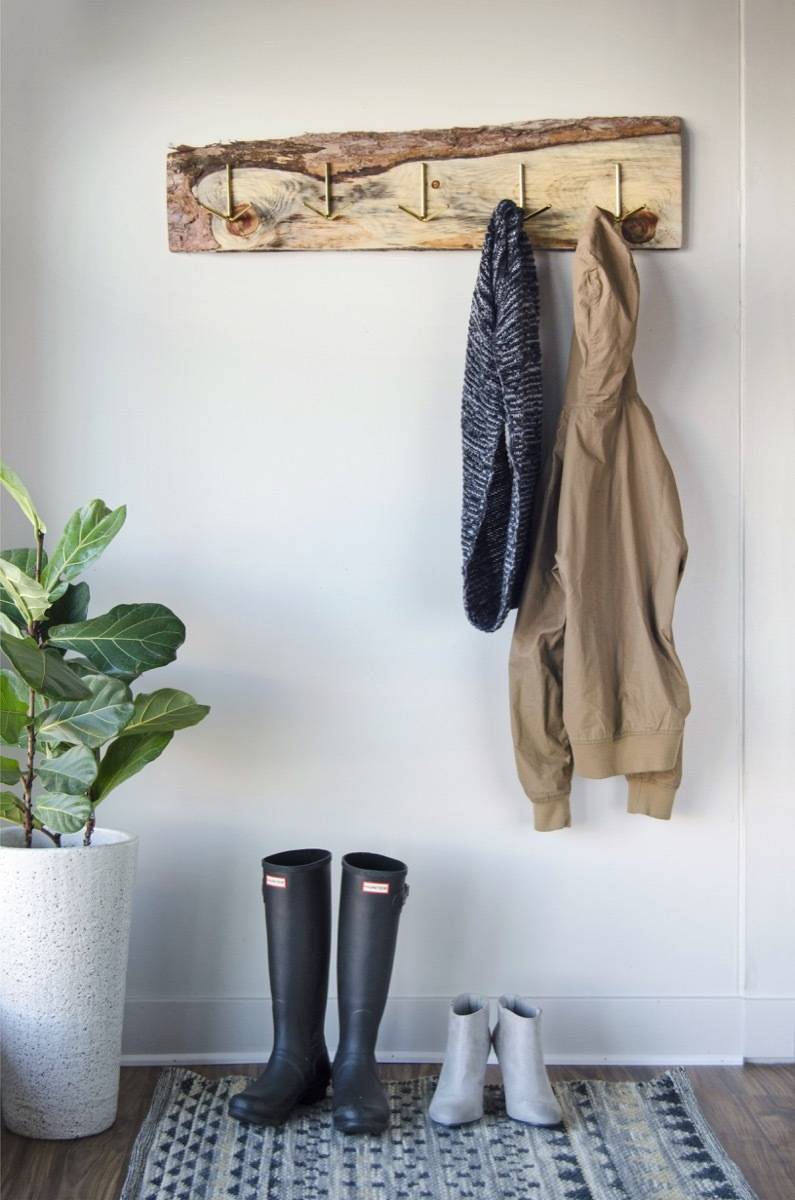 An old, discarded board gets new life as a rustic DIY coat rack