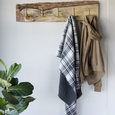 An old wood board gets new life as a rustic DIY coat rack