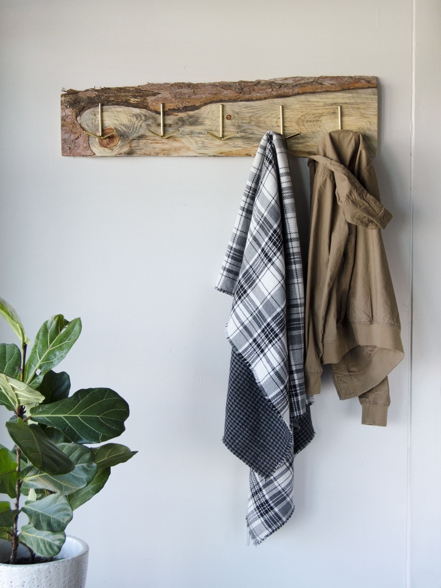 An old wood board gets new life as a rustic DIY coat rack