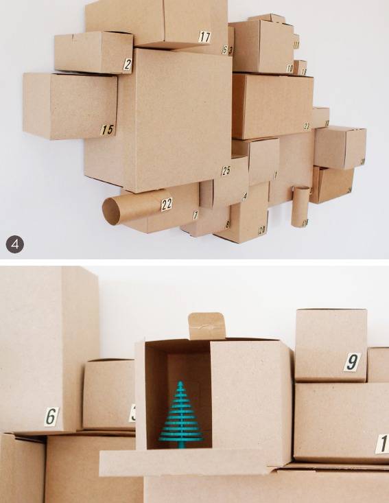 Large group of cardboard boxes and cylinders with one containing a Christmas tree decoration.