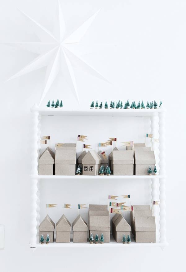 Natural colored small buildings for a Holiday village in a white box.