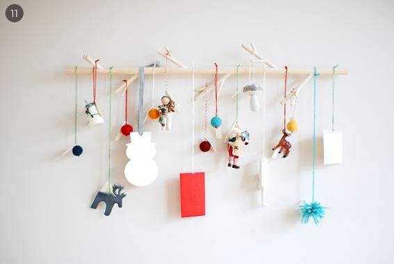Colorful Xmas crafts hang from strings.