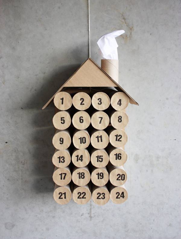 Numbers on wood circles create the dates of an advent calendar designed to look like a birdhouse.