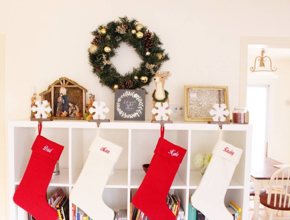 Arrange christmas stockings on a bookcase
