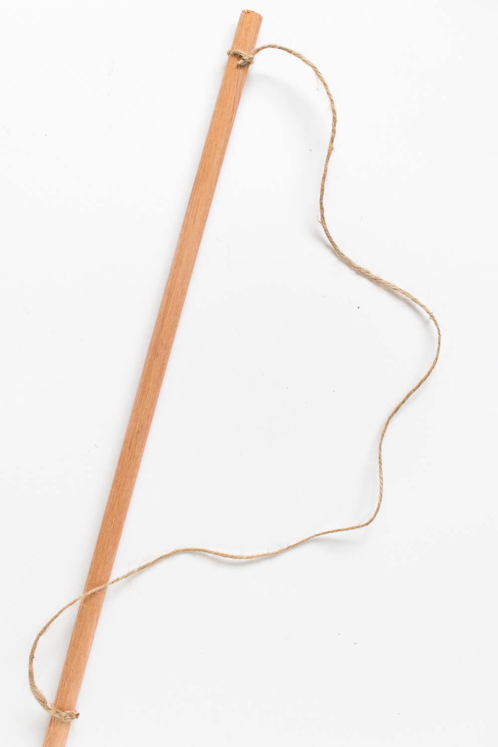 Long thin wooden stick with strings tied to each end of it.