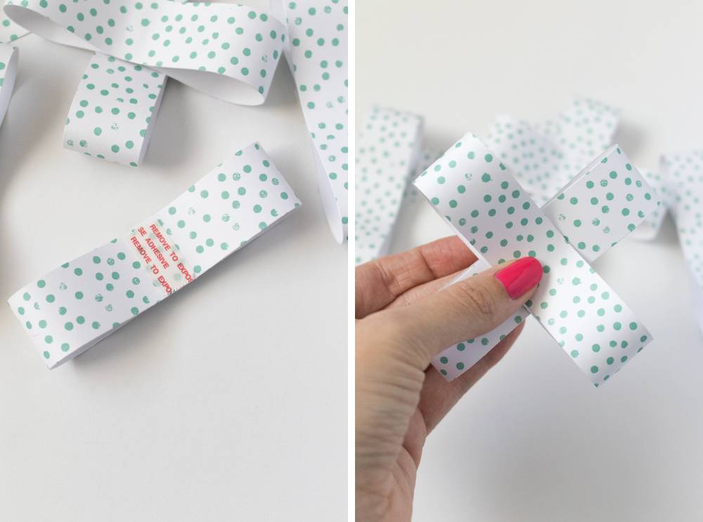 Bows being made from white paper with green polka dots.