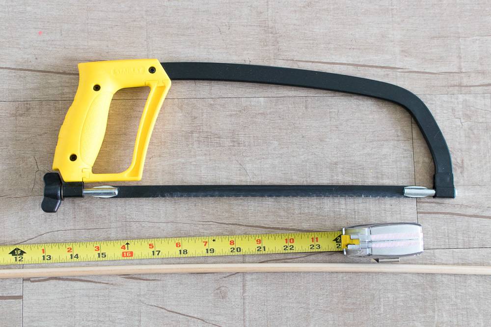 Hand hacksaw blade and measuring tape on the floor.