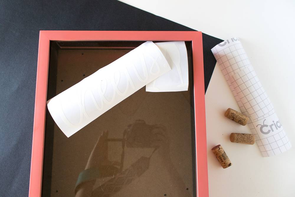 A pink picture frame with white paper on top of it