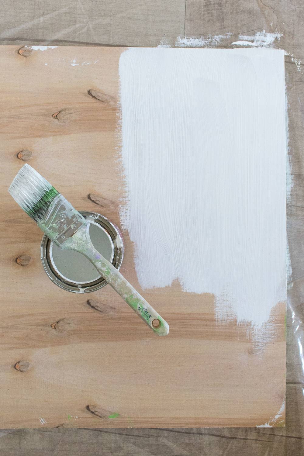 A wooden board that is one fourth painted white