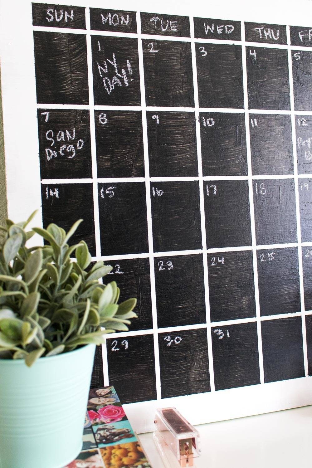 A calendar marked on a blackboard on the wall.