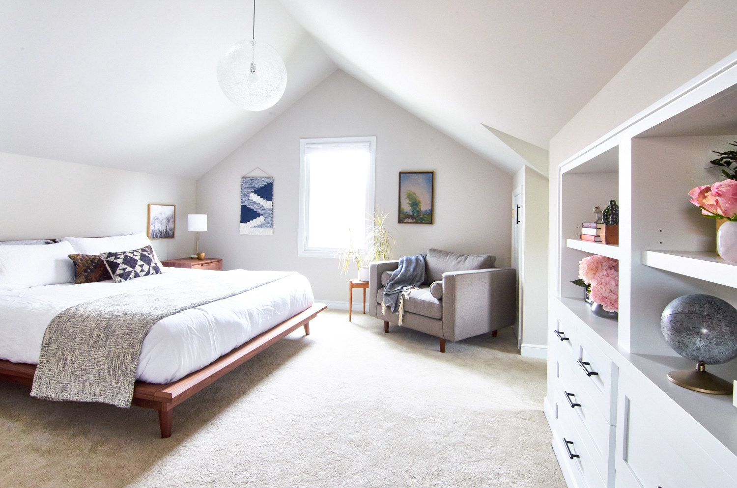 Light and airy upstairs bedroom with a pitch roof.