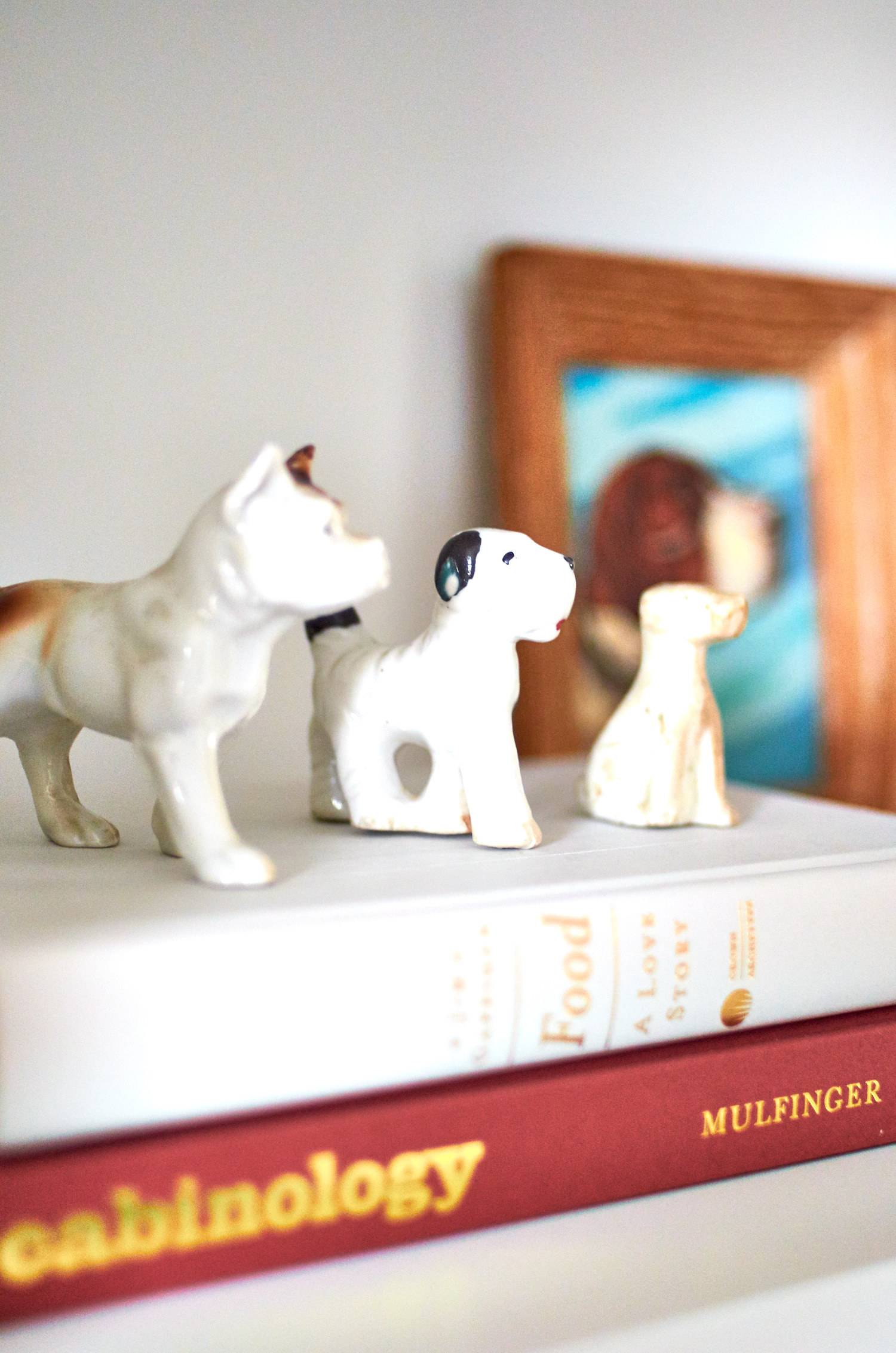 Small dog figures sitting on a stack of books.