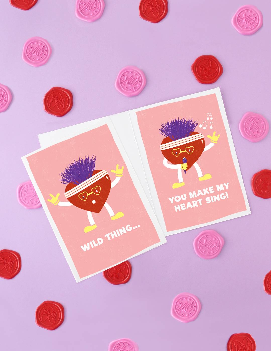 Valentines day cards on a purple, pink, and red background.