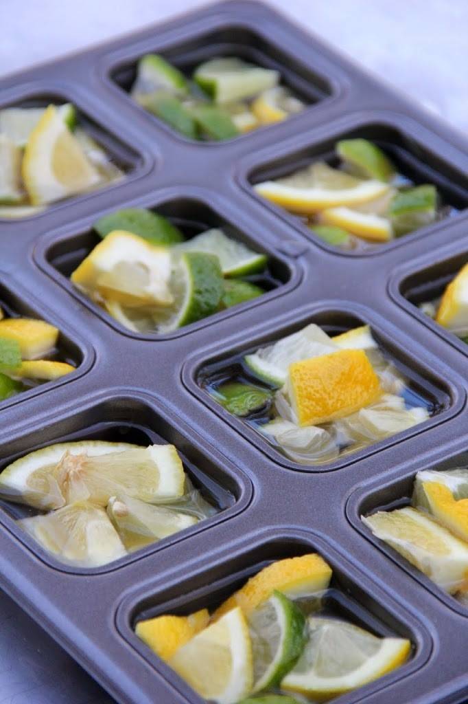 Cut-lemon pieces in small containers filled with water.