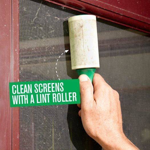 Man using a lint roller to clean the window glass.