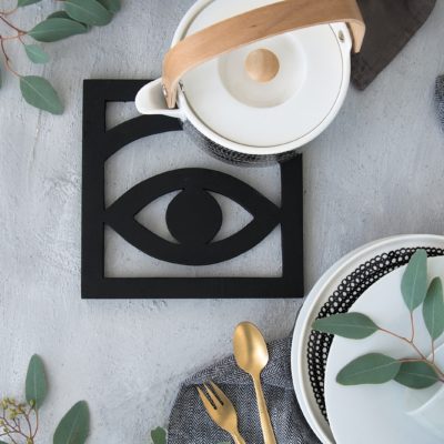A fake eye on a table with white bowls around it