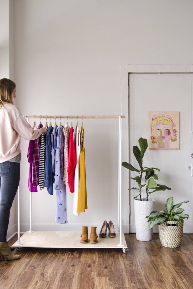 Create your own closet by crafting a rolling clothing rack with this tutorial