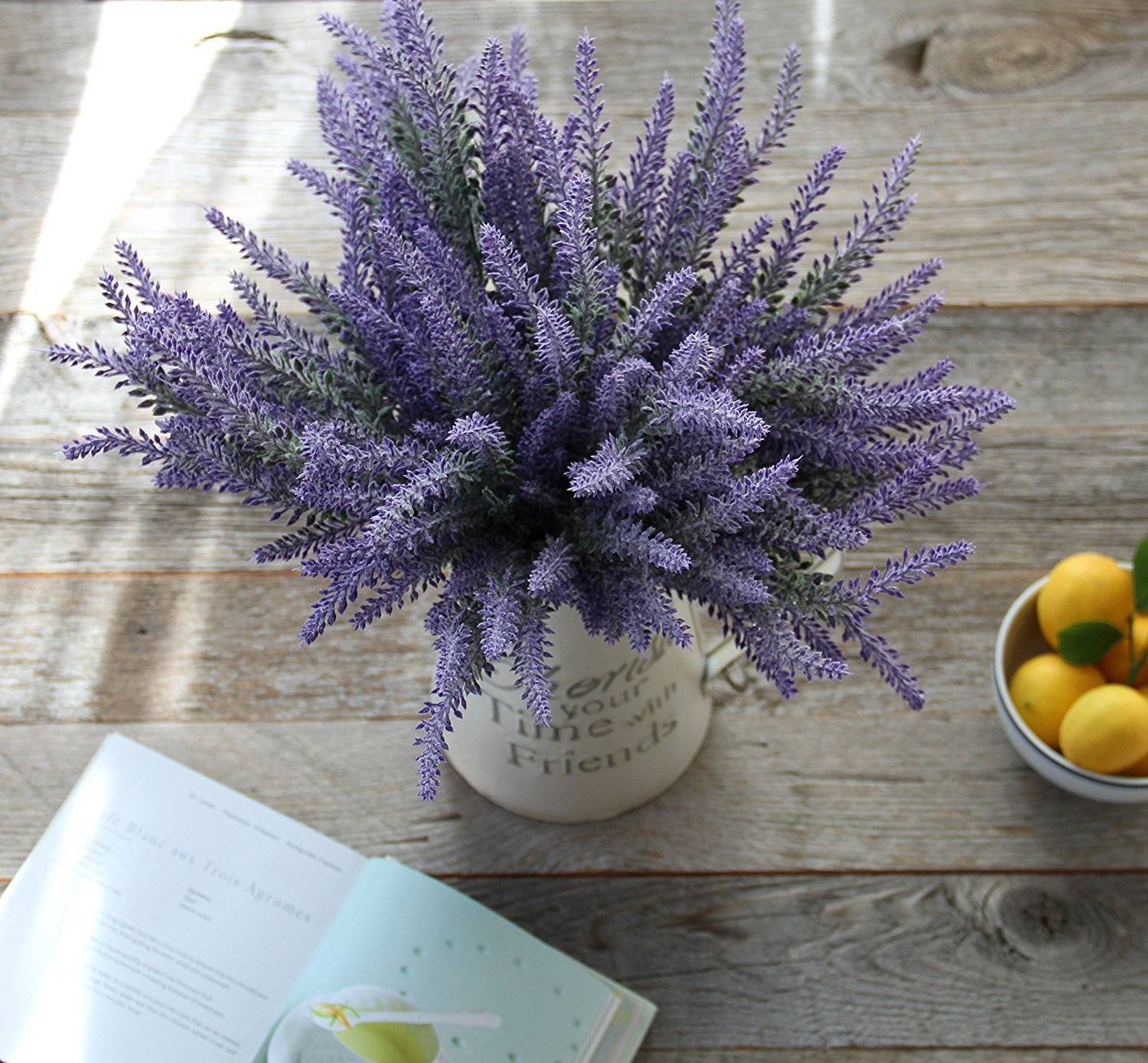 Lavender colored fake plant in a white jar.