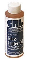 A bottle of glass cutter oil with a blue and white label sits alone.
